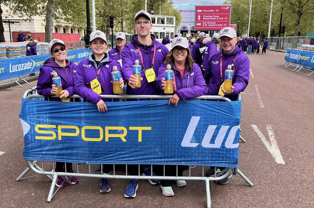 Cove Joggers members at a major road race in matching purple kit.